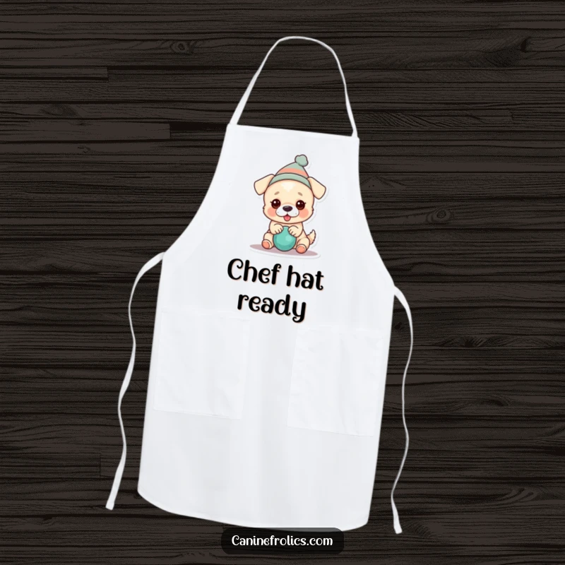 Funny dog apron showing a dog wearing a tiny hat and playing with a squeaky toy, adding fun to cooking.